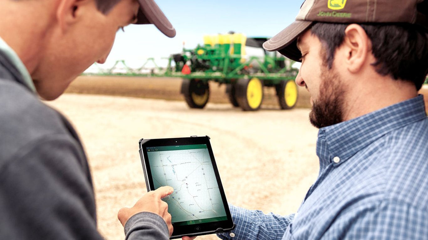 John Deere Team providing demo of remote management system on a mobile device