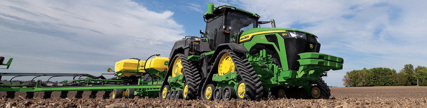 High-horsepower 8RX Tractor planting in a field.