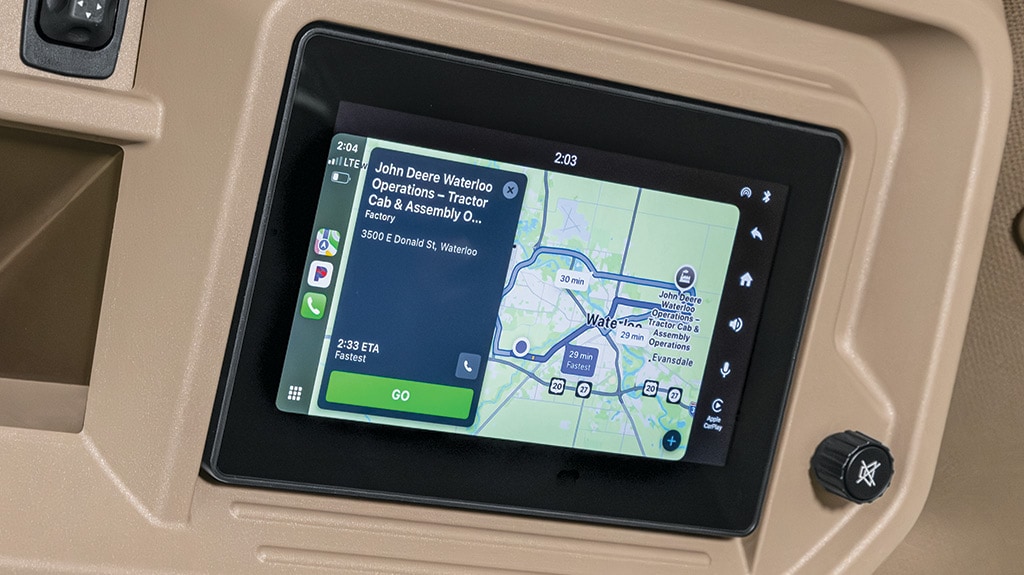 Close-up view of touchscreen radio in tractor cab.