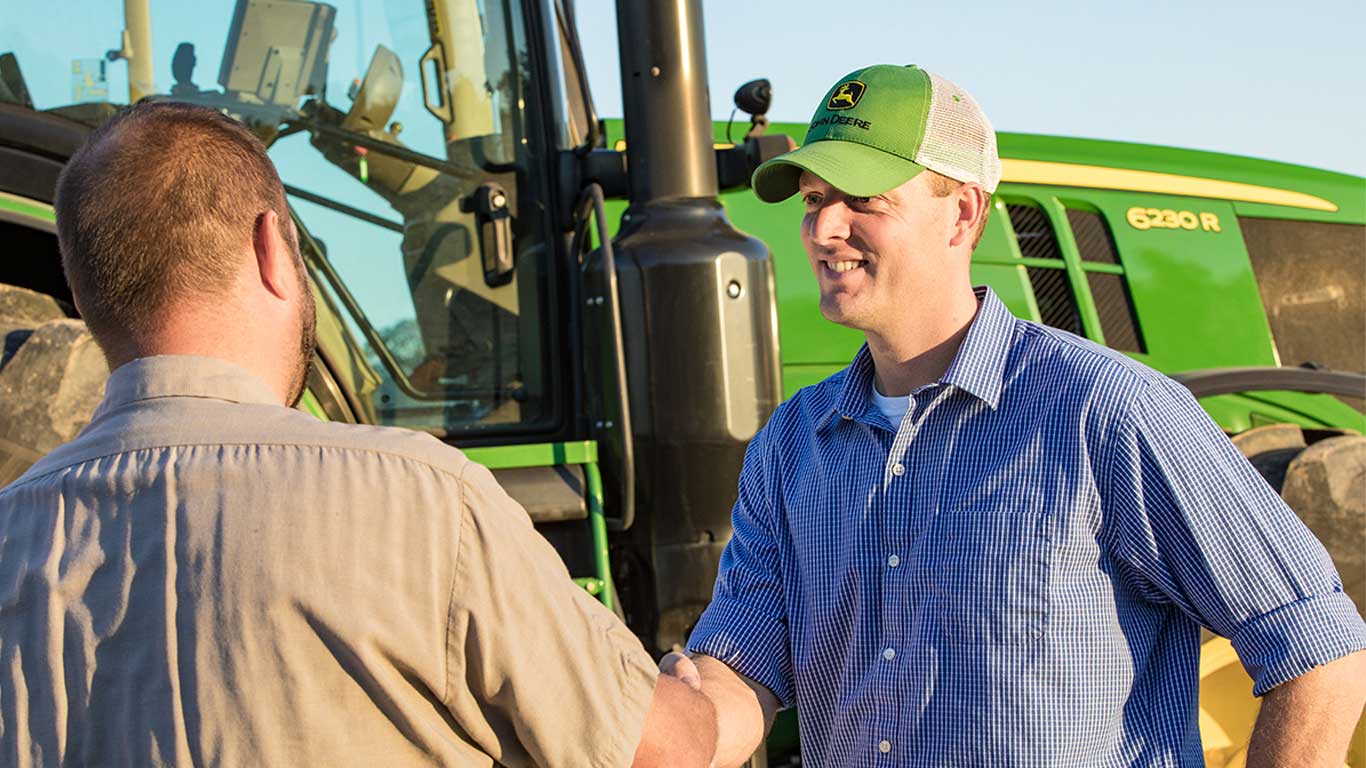 men in front of tractor