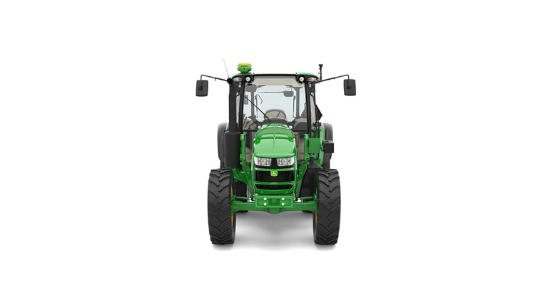 Front view of green tractor with large black tires, cab, mirrors, and lights.