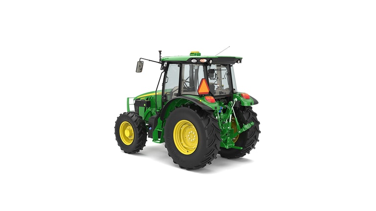 Rear view of green and yellow tractor with large tires and orange triangular safety sign.
