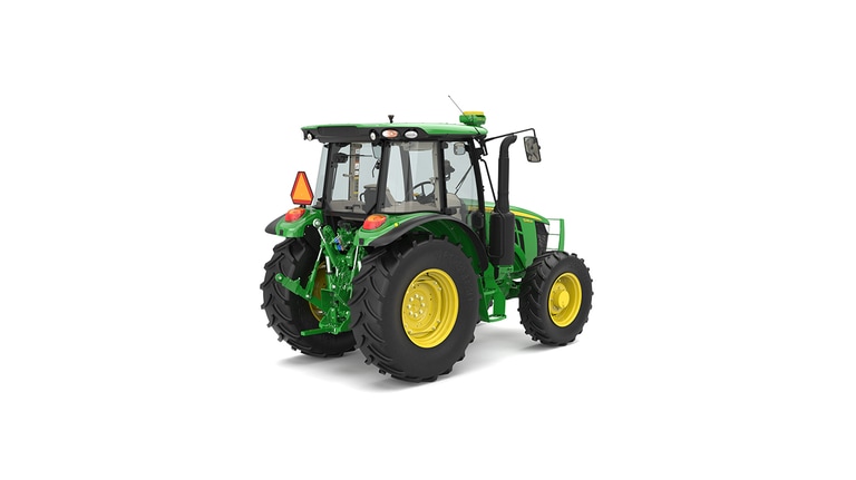 Rear view of green and yellow tractor with large tires and orange triangular reflector.