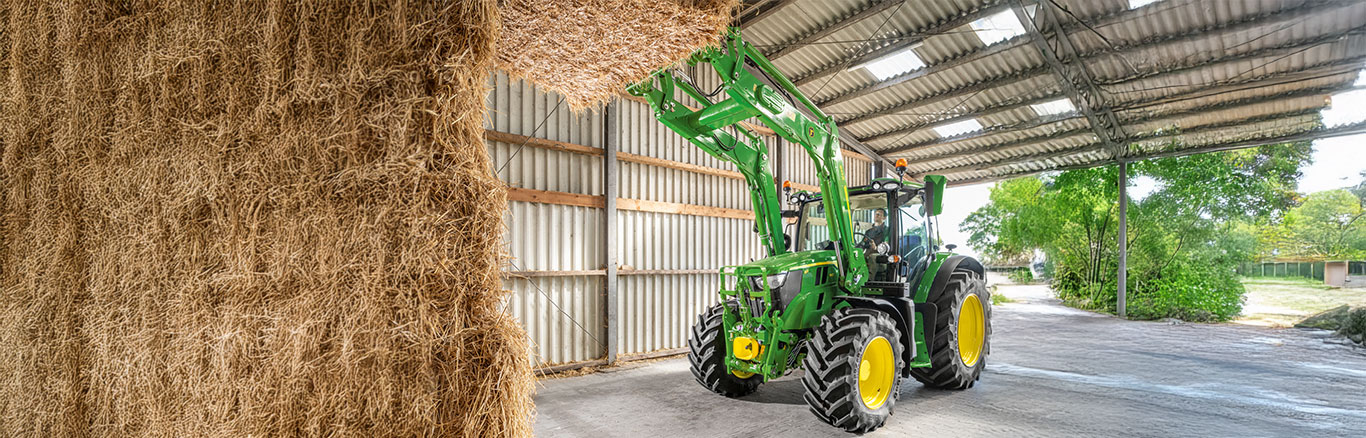 6R series tractor with front loaded hay bale
