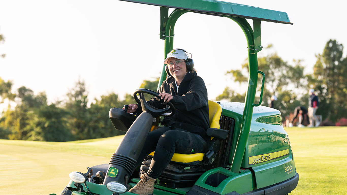 Brody Cooper smiling toward camera, sitting on mower at Cobram Barooga Golf Club.